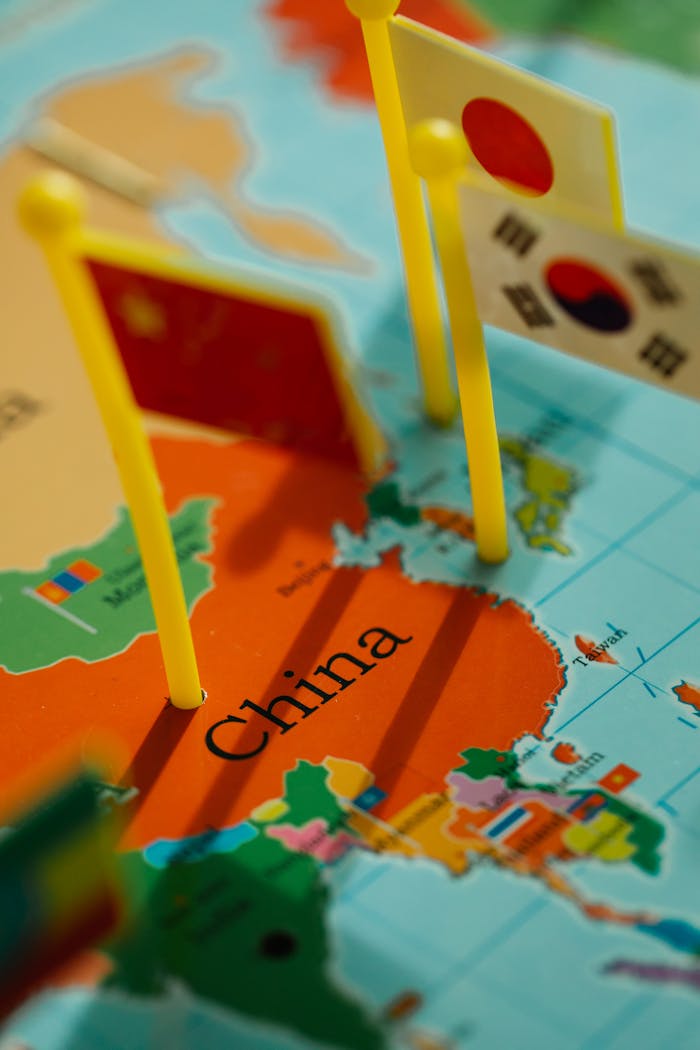gallery-2 Flags representing Asian countries on a detailed map of China. Vibrant colors and focus on China.